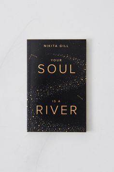 a black book with gold lettering that says,'soul is a river'on it