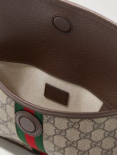 Gucci's 'Ophidia' belt bag has been crafted in Italy from monogrammed coated-canvas in classic shades of brown. Detailed with a gold emblem, it's trimmed with durable full-grain leather and signature striped webbing. Luxury Belt Bag Pouch, Luxury Pouch-shaped Belt Bag, Designer Pouch Belt Bag With Detachable Strap, Luxury Coated Canvas Belt Bag For Everyday, Designer Monogram Canvas Crossbody Belt Bag, Luxury Belt Bag With Removable Pouch In Coated Canvas, Classic Monogram Canvas Belt Bag With Removable Pouch, Brown Leather Gucci Belt Bag, Gucci Brown Leather Belt Bag