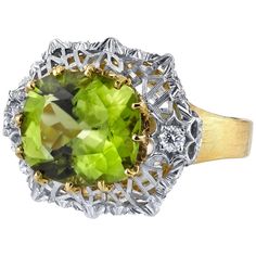 A velvety, grass-green, cushion-cut peridot is showcased in this beautiful, Florentine style ring. The center peridot is set horizontally, surrounded by an intricately-pierced, white gold design that sits atop a brushed finished yellow gold band. Fine, brilliant cut diamonds add even more sparkle and elegance to this one-of-a-kind ring. Handmade in 18k yellow and white gold by our artisans in Italy. Peridot, 12.15 x 10.71mm, 5.70 carats Round brilliant cut diamonds, .20 carat total Ring size 7 C Peridot Jewelry, Diamond Fashion Rings, White Diamond Ring, Gold Cocktail Ring, Diamond Jewelry Designs, Peridot Ring, Green Diamond, Green Peridot, Enamel Ring