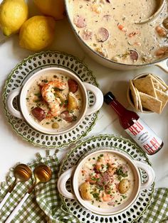 three bowls filled with soup next to some lemons and other food on the table