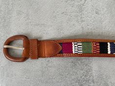 Tan leather belt with a colourful woven cotton centre in an aztec pattern.  Leather backing. Stamped 50% Leather 50% cotton made in Guatemala.  Leather covered buckle . Size 95 - 100.5 cm. Theres also an additional hole been put at 75cm 3 cm high The belt is a little warped but makes no difference when wearing it. Fair condition.  Please note this is a vintage item (second hand / not new) , so may have signs of wear. However, anything major will be listed and photographed. Handmade Belt, Tan Leather Belt, Handmade Belts, Aztec Pattern, Suspender Belt, Aztec Print, Woven Cotton, Leather Cover, Suspenders