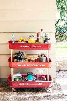 a red wagon filled with drinks on top of a patio