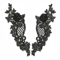 two pieces of black lace with flowers on them