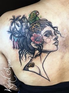 a woman's back with a tattoo on her shoulder and an image of a bird