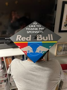 a person wearing a red bull graduation cap