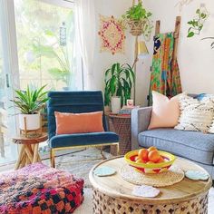 a living room filled with furniture and lots of plants