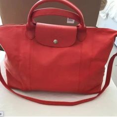 Authentic Longchamp Le Pliage Cuir Red All Leather Large Tote Bag. Brand New Without Tag. Come With A Dust Bag.Measures Approximately 20 Inches X 12 Inches X 6 Inches Red Shoulder Bag With Leather Lining For Travel, Red Leather Lined Shoulder Bag For Travel, Red Leather Lining Shoulder Bag For Travel, Red Shopping Bags With Leather Lining, Red Leather-lined Bags For Shopping, Classic Red Shoulder Bag With Leather Handles, Classic Red Bags With Leather Handles, Red Shopping Bag With Snap Closure, Red Bags With Snap Closure For Shopping