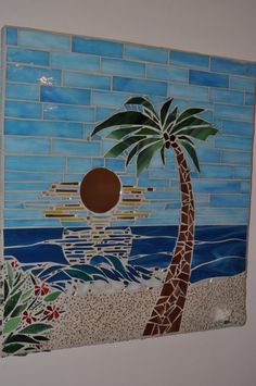 a tile wall with a palm tree on it