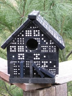 a bird house with holes in the roof