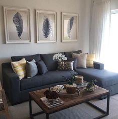 a living room filled with furniture and pictures on the wall above it's coffee table