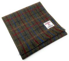 Authentic Harris Tweed Scarf - in a Green Tartan Design Handwoven in the Outer Hebrides of Scotland This beautiful Harris Tweed Scarf is made from 100% pure virgin wool and is handwoven in the Outer Hebrides of Scotland. It is the perfect accessory for any occasion, and is sure to keep you warm and stylish all winter long. The scarf is approximately 59 inches long and 9.8 inches wide, and features a fringed edge. It is made from a blend of colours that is both stylish and classic, and is sure to complement any outfit. Harris Tweed is a registered trademark and is protected by law. It is the only fabric in the world that is governed by its own Act of Parliament. This ensures that Harris Tweed is made to the highest standards of quality and craftsmanship. When you buy a Harris Tweed scarf, y Tweed Scarf, Baker Boy Hat, Green Tartan, Outer Hebrides, Tartan Scarf, Scarf Handmade, Tartan Design, Unique Nature, Flat Cap