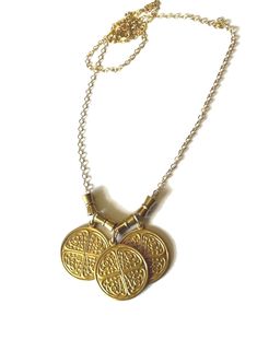 Triple Byzantine Brass Token Necklace with hourglass bead accents on 14K gold-filled chain.  This is a really unique and fun necklace. It has a whimsical charm and is easy to wear with most anything.  Please contact me with any questions. If you require specific measurements, please don't hesitate to ask.  I hope you love your item(s) as much as I loved making it. Please don't hesitate to reach out to me if you have any special requests or alterations. I am happy to make changes to pieces in my store to suit your needs so long as I am capable of doing so. Shipping will take place within approximately 3 business days. All sales are final, HOWEVER, if the item is not as described, has flaws that hinder its functionality or breaks within the first 30 days, I will be happy to repair or replace Gold Brass Necklaces For Blessing, Gold Brass Necklace For Blessing, Gold Brass Necklace For Blessings, Brass Byzantine Necklace Perfect For Gifts, Symbolic Gold Charm Necklaces Nickel Free, Bohemian Gold Nickel-free Charm Necklaces, Bohemian Gold Nickel-free Charm Necklace, Bohemian Gold Charm Necklace, Gold Amulet Charm Necklace Nickel-free