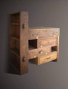 an old wooden desk with drawers on the bottom and one drawer open to reveal something