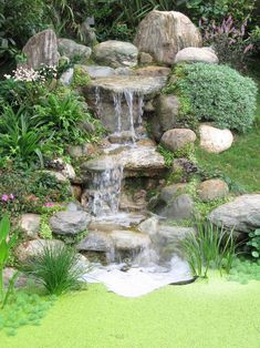 a small waterfall in the middle of a garden