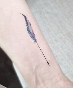 a small feather tattoo on the left inner forearm and wrist with an arrow in it