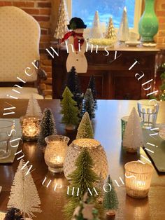 a table with candles and christmas trees on it