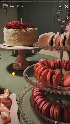 there are many different types of pastries on the table and one is decorated with roses