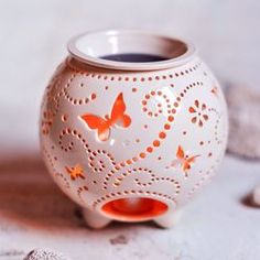 a white vase with orange butterflies on it