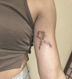 a woman with a flower tattoo on her arm