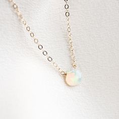 "The most perfect necklace for opal lovers! This dainty necklace includes an authentic Ethiopian Welo opal, around 6-8mm. The chain is available in either 14k gold filled or sterling silver, along with respective clasps/findings. This is the perfect necklace for minimalists. It's great for wearing alone or layering with other necklaces. Wear as a dainty necklace as a pop to any outfit! . . . . . . . . . . . . . . . . . . . . . . . . . . . . . . . . . . . . . . . . . . NECKLACE + Length: 16\" + 2 Opal Necklace Simple, Tiny Gold Necklace, Dainty Opal Necklace, Opal Necklace Gold, Girlfriend Necklace Gift, Detailed Necklace, Wedding Rings Solitaire, Classic Engagement Rings, Bridesmaid Necklace