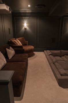 a living room filled with lots of couches and pillows on top of carpeted flooring