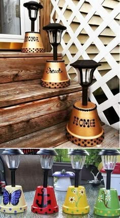 four different colored lights sitting on top of a wooden porch steps next to a white picket fence