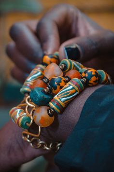 The hand painted krobo beads are famous for their intrigueing color combinations.We created this beautiful bracelet with antique Turquoise Hebron beads,recycled Gas beads and ceramic Krobo beads. This bracelet is 7.5 inches long with extra links to allow for adjustment.Its width spans to almost 2 inches and is light on the wrist. We use art as a vehicle to create sustainable income for the young women we work with. Thank you for visiting our store! Xoxoxo Atiamuga Cheap Orange Bohemian Beaded Bracelets, Cheap Handmade Statement Stretch Bracelet, Affordable Statement Jewelry With Wooden Beads, Affordable Large Beads Hippie Jewelry, Affordable Bohemian Wooden Beads Stretch Bracelet, Artisan Bracelets With Wooden Round Beads, Luxury Multicolor Jewelry With Wooden Beads, Cheap Orange Bohemian Stretch Bracelet, Artisan Green Beaded Bracelets With Wooden Beads