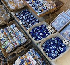 an assortment of blue and white items for sale at a street vendor's stall