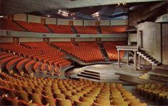 an empty auditorium with rows of seats