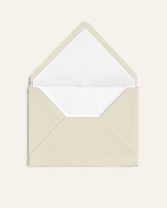 an open envelope with a white paper inside on a beige background, showing the bottom corner