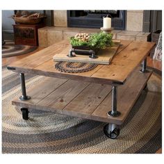 a coffee table with wheels on it in front of a fire place and rugs