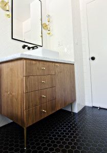 a bathroom vanity with a mirror above it