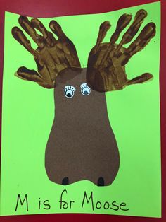 a handprint moose with eyes and hands on it