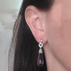 These amethyst drop earrings are crafted in 18 Karat white gold. Featuring 48 round brilliant cut diamonds of VS Clarity and G/H Color totaling 0.48 Carats. These earrings measure 1.75 inches long and have pierced posts with supportive, large friction backs. Diamond Drop Earrings, G H, Round Brilliant Cut Diamond, Round Brilliant, Amethyst, Diamonds, White Gold, Drop Earrings, Gold