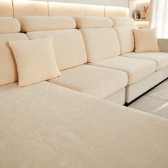 a white couch with lots of pillows on it