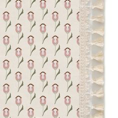 a blanket with pink flowers on it and fringes hanging from the side, in front of a white background