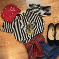 a pair of black and white striped shirts, jeans and shoes