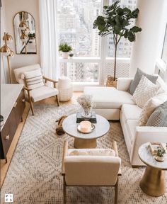 a living room with couches, chairs and tables in front of a large window