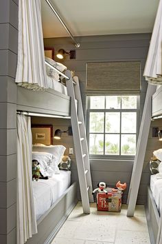 two bunk beds with ladders are shown in this photo, and one has a basket on the floor