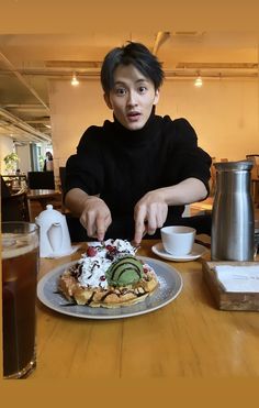 a person sitting at a table with a plate of food