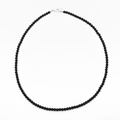 Black Onyx beads are hand strung to form this classic single strand necklace. The beads are tiny measuring about 3.0mm. This is a beautifully tiny, and delicate onyx necklace. You could wear this alone or stack with other necklaces for a layering effect.• 3mm round black Onyx beads• 925 Sterling silver or 14/20 Gold Filled lobster clasp and ring• Available in 14" to 42" lengthsI have hand strung these beads using a premium beading wire that has beautiful drape and it fastens with a sterling silv Black Onyx Jewelry, Black Onyx Necklace, Black Beaded Jewelry, Onyx Jewelry, Black Bead Necklace, Gemstone Beaded Necklace, Onyx Necklace, Onyx Bracelet, Onyx Bead