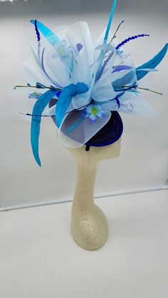 Beautiful multi blue color Fascinator with feathers and flowers. Style to go with a variety of outfits: bridesmaids, cocktail party, Kentucky Derby, Rehearsal dinner, Easter and church outfits. Ones with hair clip and headband. Are you trying to match an outfit? Send a picture and I will help you find a best hat to match your outfit. - Rare find - Ready to ship - Lightweight - Free Shipping - Fast shipping - Customize by adding different color flowers and or feathers Check my store for for style Blue Mini Hats With Handmade Flowers For Royal Ascot, Blue Summer Wedding Costume Hats And Headpieces, Spring Blue Fascinator For Garden Party, Light Blue Headpiece For Royal Ascot Party, Blue Costume Hats And Headpieces For Summer Wedding, Blue Spring Fascinator For Garden Party, Summer Blue Headpiece With Handmade Flowers, Light Blue Headpieces For Spring Wedding, Spring Blue Mini Hats With Handmade Flowers