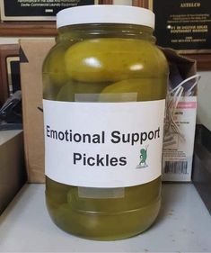 a jar of pickles sitting on top of a counter