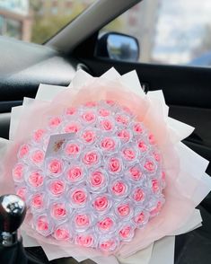 a bouquet of roses sitting on top of a car dashboard