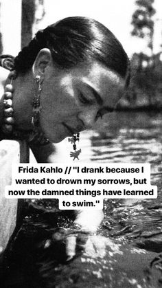 a black and white photo of a woman in the water with her hand on her face