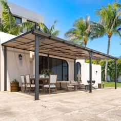 a patio covered with furniture and palm trees