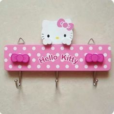 a hello kitty sign hanging from hooks on a wall