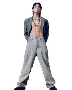 a man with no shirt standing in front of a white background wearing grey pants and a gray blazer