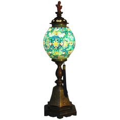 a lamp that is sitting on top of a wooden stand with a glass ball in the middle