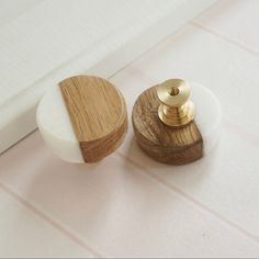 two wooden knobs with white and wood accents